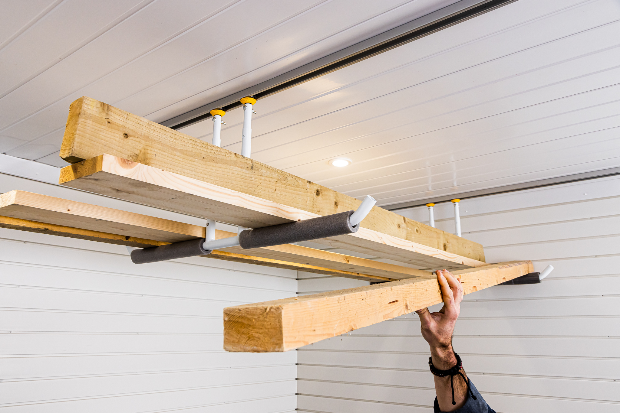 Adjustable storage rack for the garage ceiling